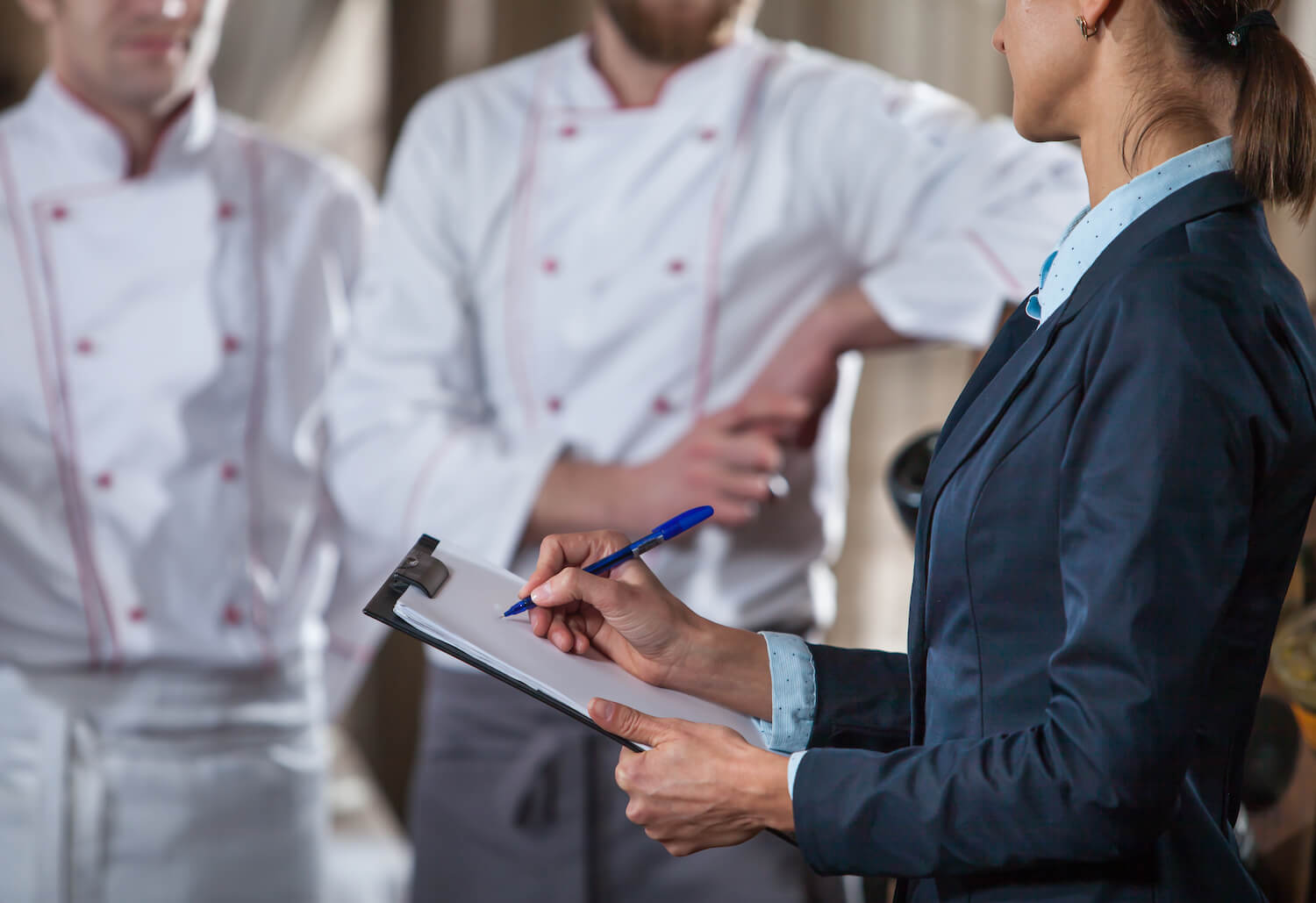 Auditor with clipboard in kitchen small