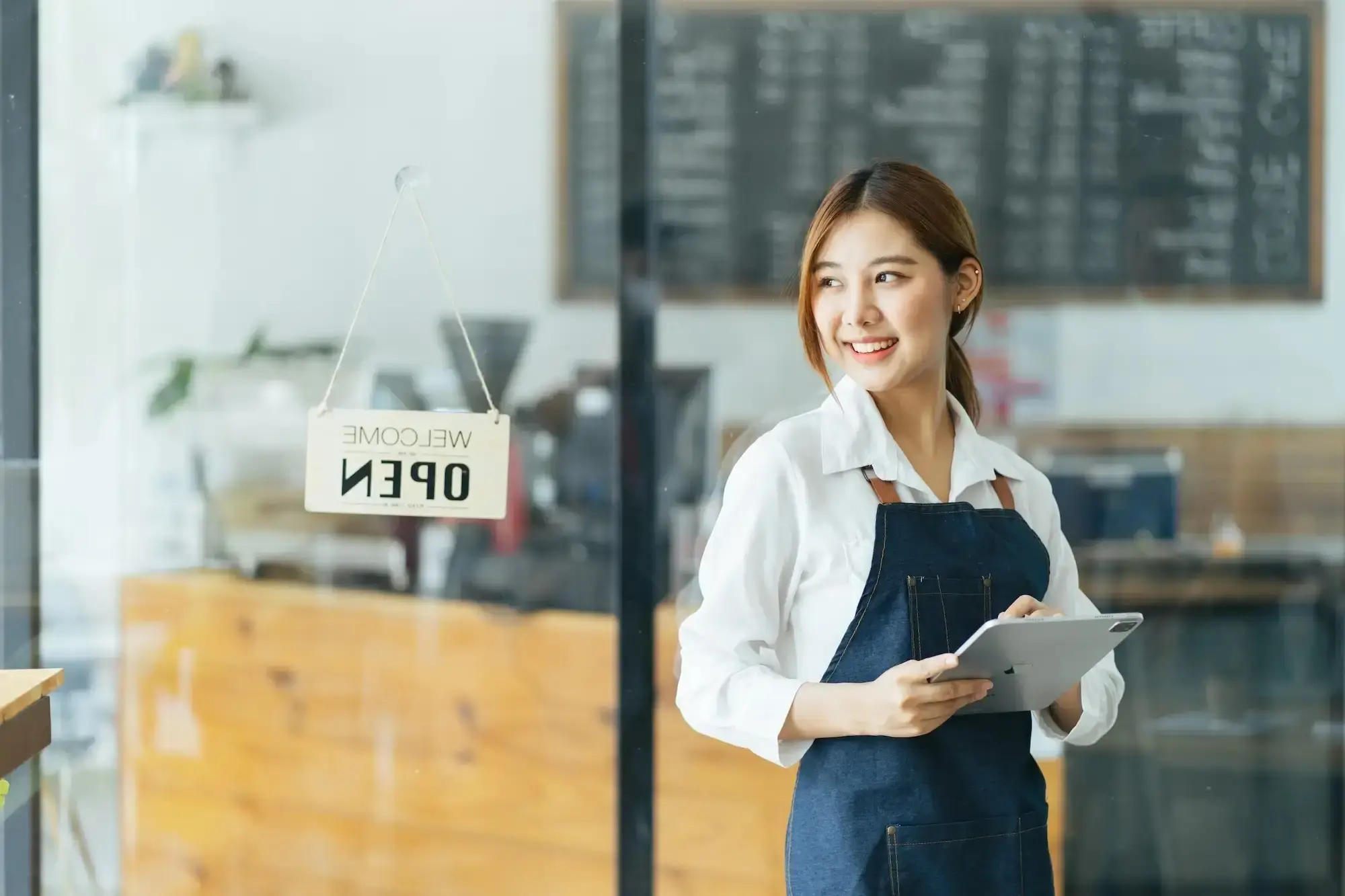 female cafe staff with ipad
