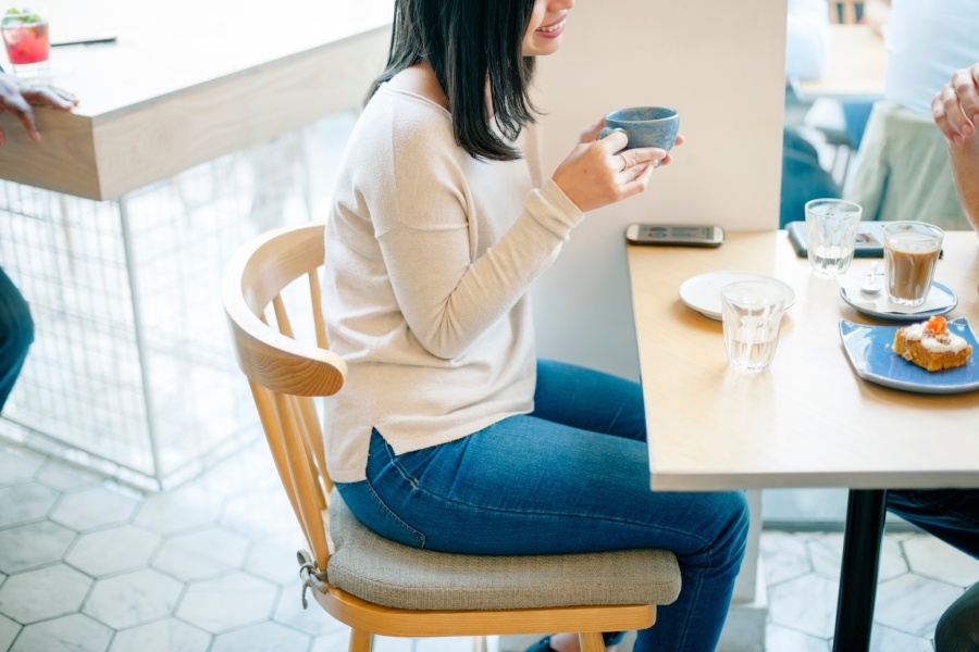 woman-in-cafe-with-phone.jpeg